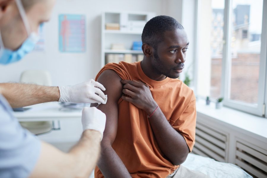 Image of healthcare professional giving an injection to a patient 