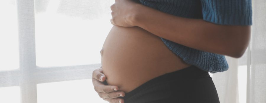 Decorative image of a pregnant person's belly