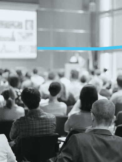 People sitting in a large conference hall.