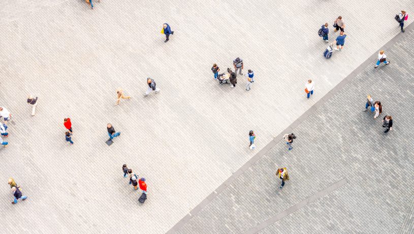 Aerial view of a public square with people walking in various directions